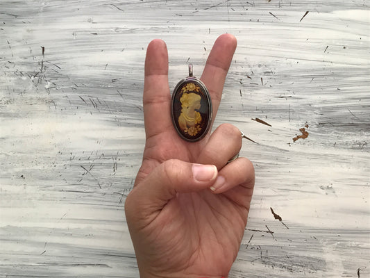 Large cameo carved amber pendant