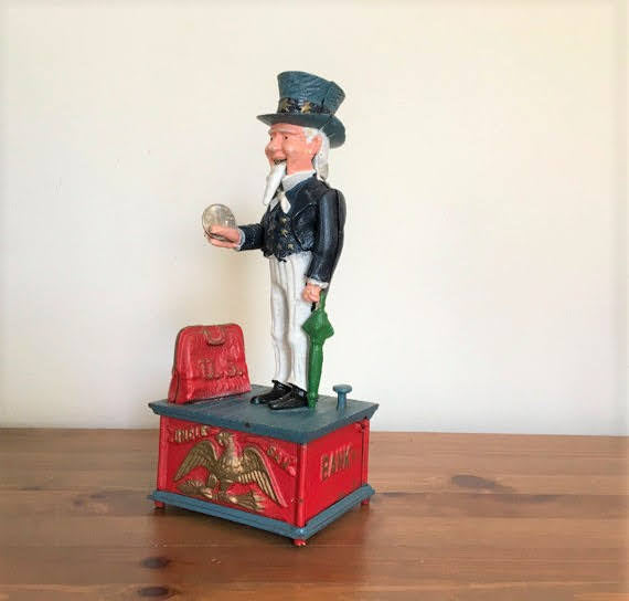 Antique Uncle Sam coin drop into bank